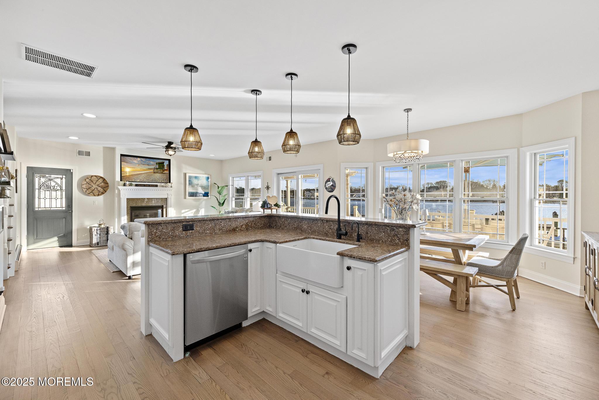 55 Bay Way Brick, NJ 08723 - Photo 10 of 29 a open kitchen with stainless steel appliances granite countertop a stove and chairs with wooden floors