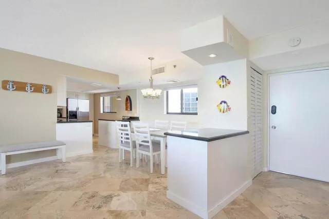 a kitchen with granite countertop cabinets and refrigerator