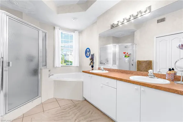 a bathroom with a tub sink and mirror