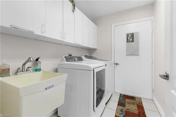 a utility room with sink dryer and washer