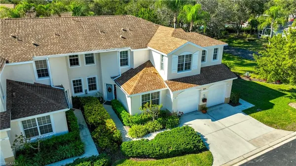 an aerial view of a house with a yard