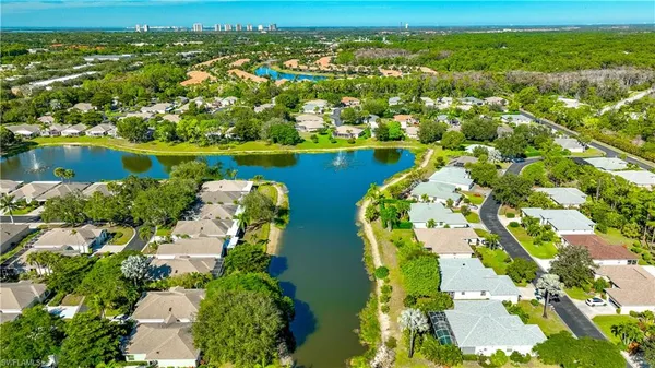 an aerial view of residential houses with outdoor space and river