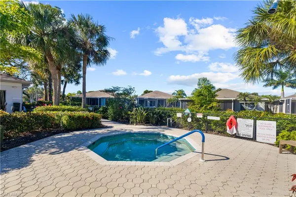 a swimming pool with outdoor seating and barbeque oven