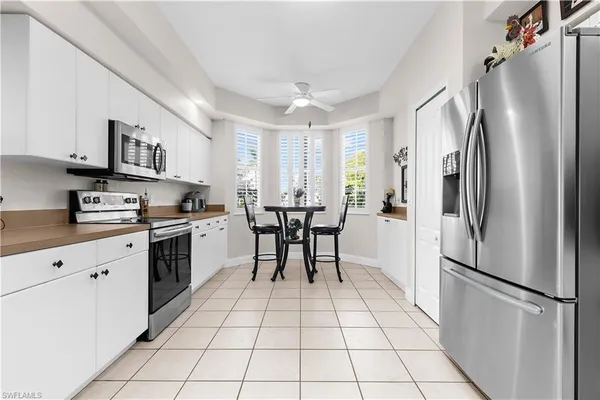 a kitchen with stainless steel appliances a refrigerator sink and cabinets