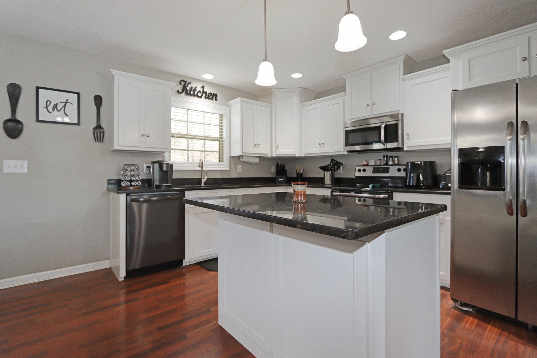 12 Haven Way Westmoreland, TN 37186 - Photo 11 of 16 a kitchen with stainless steel appliances granite countertop a sink a stove a refrigerator a center island and cabinets
