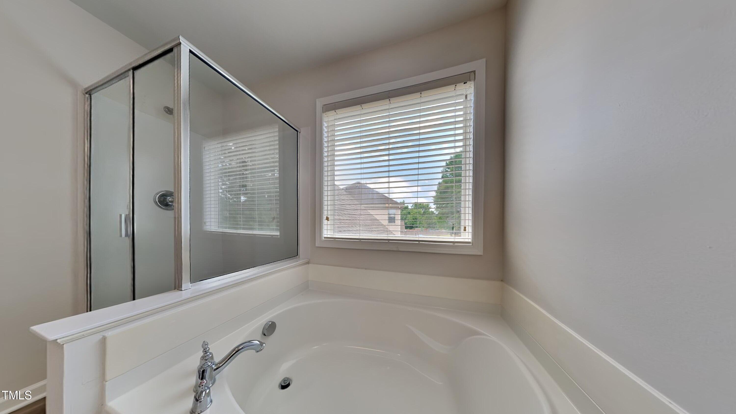 9037 Linslade Way Wake Forest, NC 27587 - Photo 11 of 16 a bathroom with a bathtub and a shower