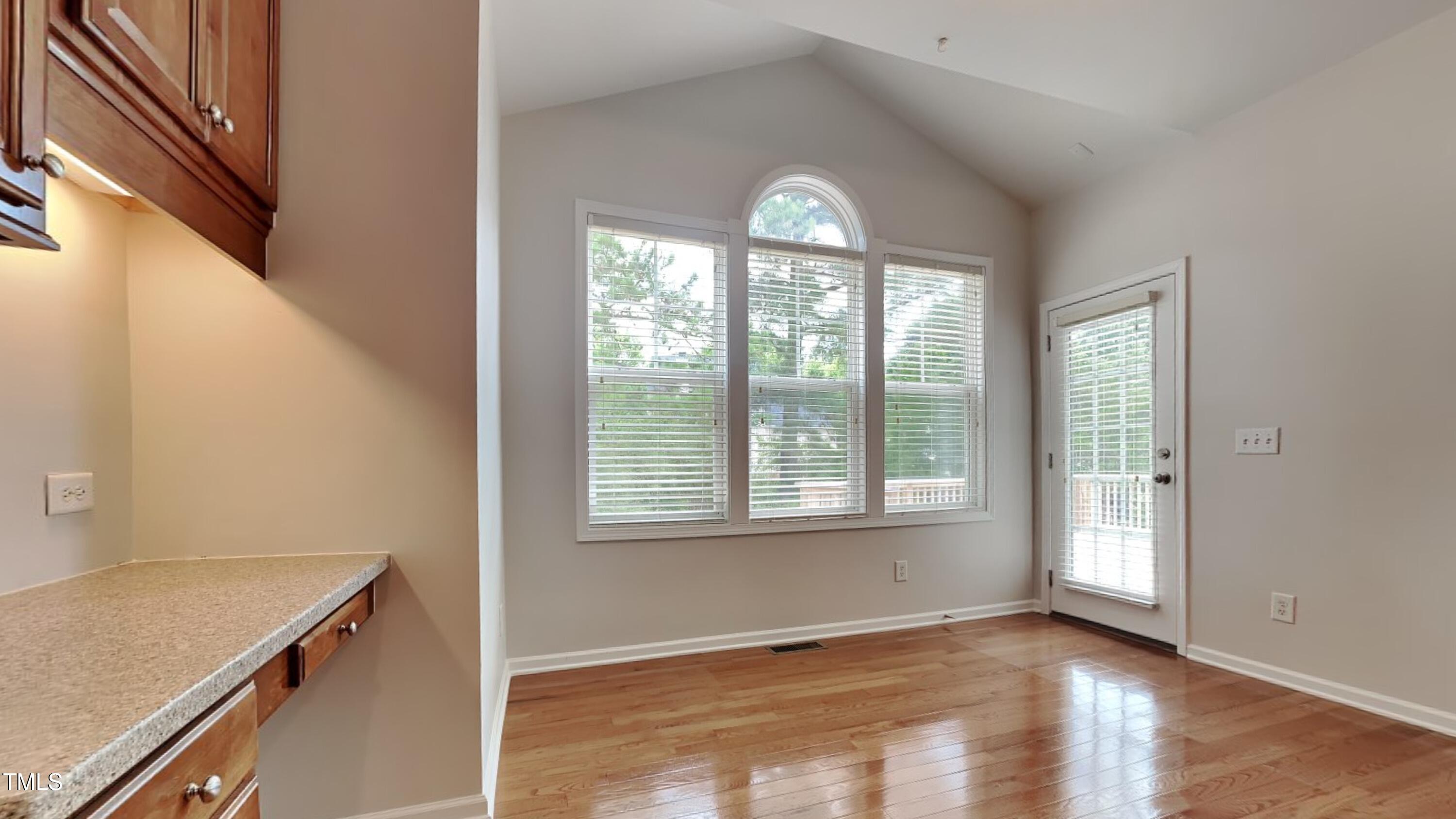 9037 Linslade Way Wake Forest, NC 27587 - Photo 6 of 16 a view of an empty room with wooden floor and a window