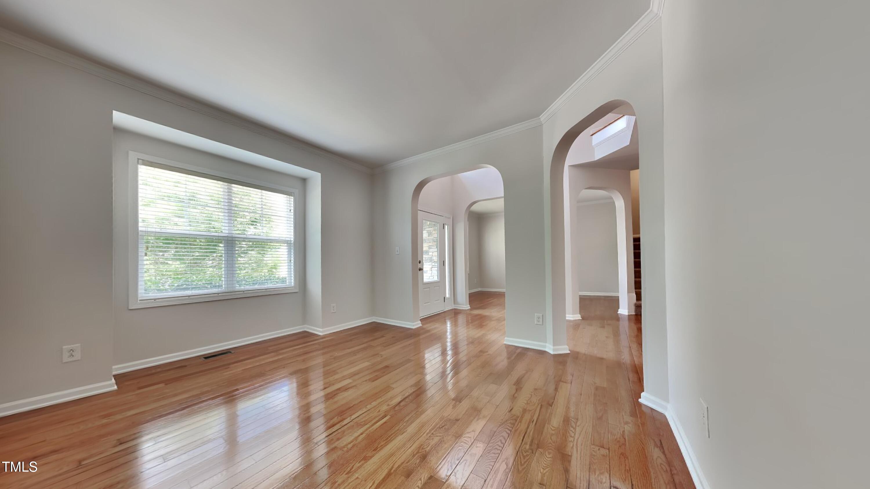 9037 Linslade Way Wake Forest, NC 27587 - Photo 7 of 16 an empty room with wooden floor and windows