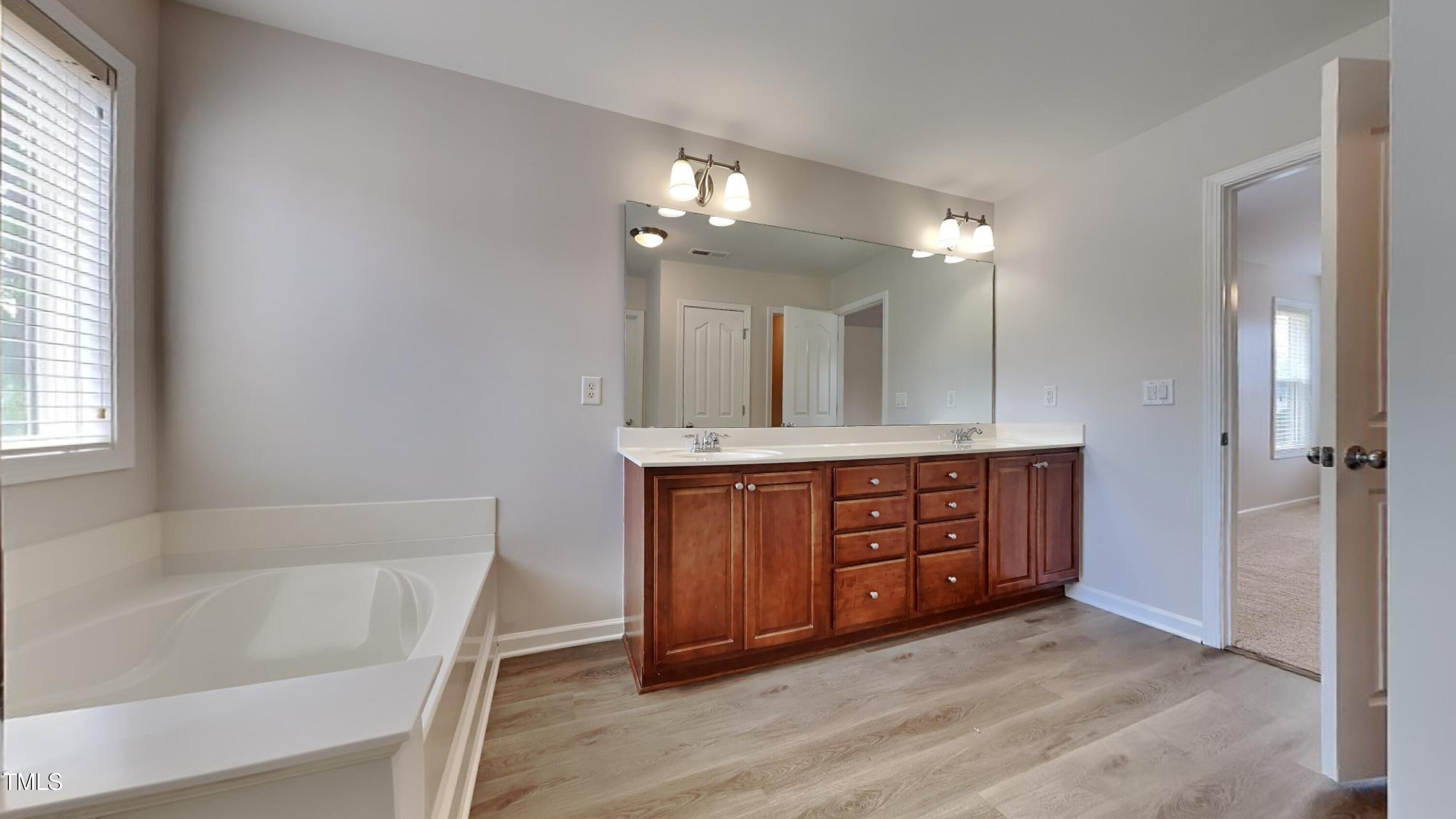 9037 Linslade Way Wake Forest, NC 27587 - Photo 9 of 16 a bathroom with a tub sink and mirror