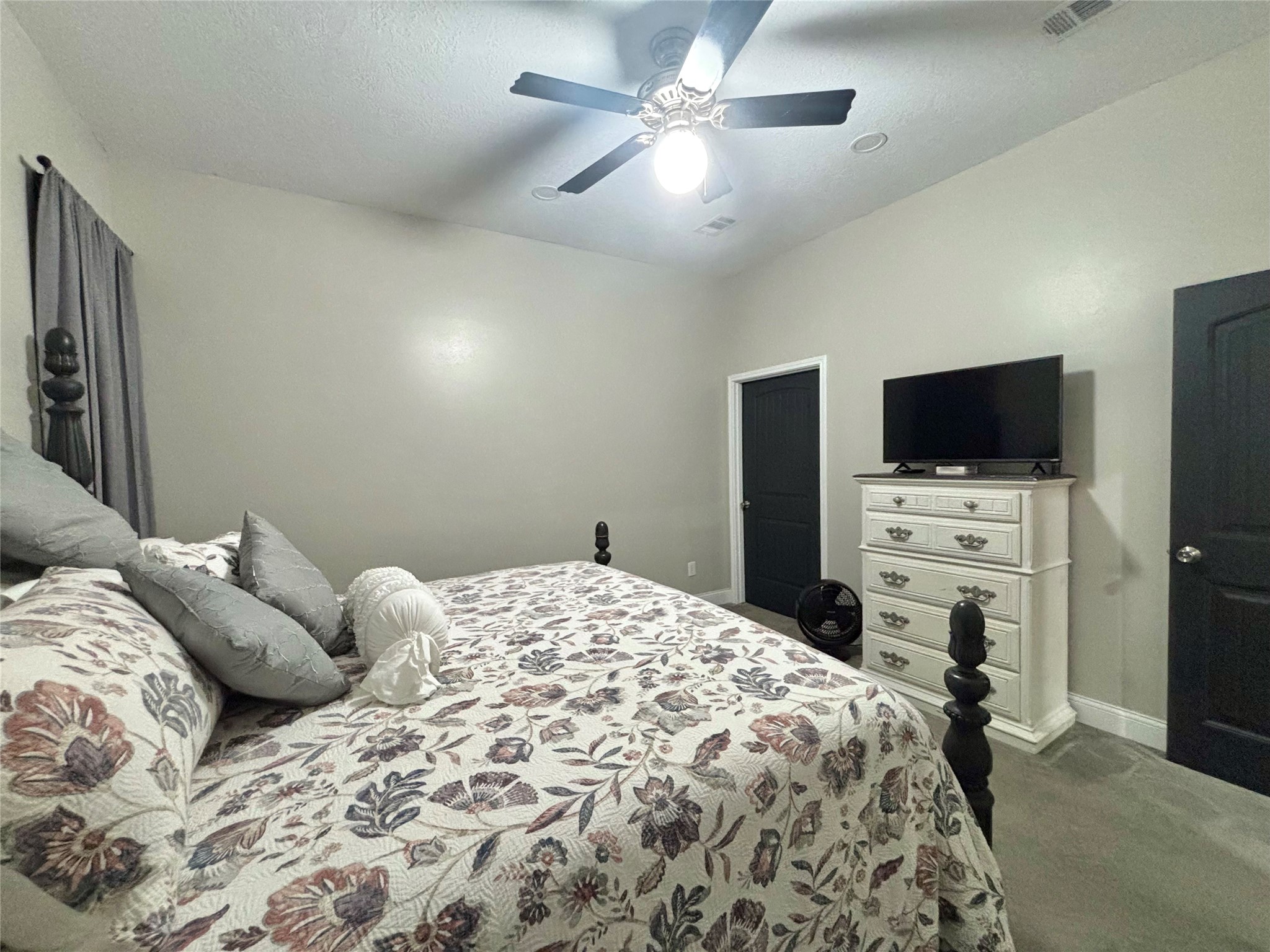 516 County Road 4800 Warren, TX 77664 - Photo 24 of 50 a bedroom with a bed and a flat screen tv