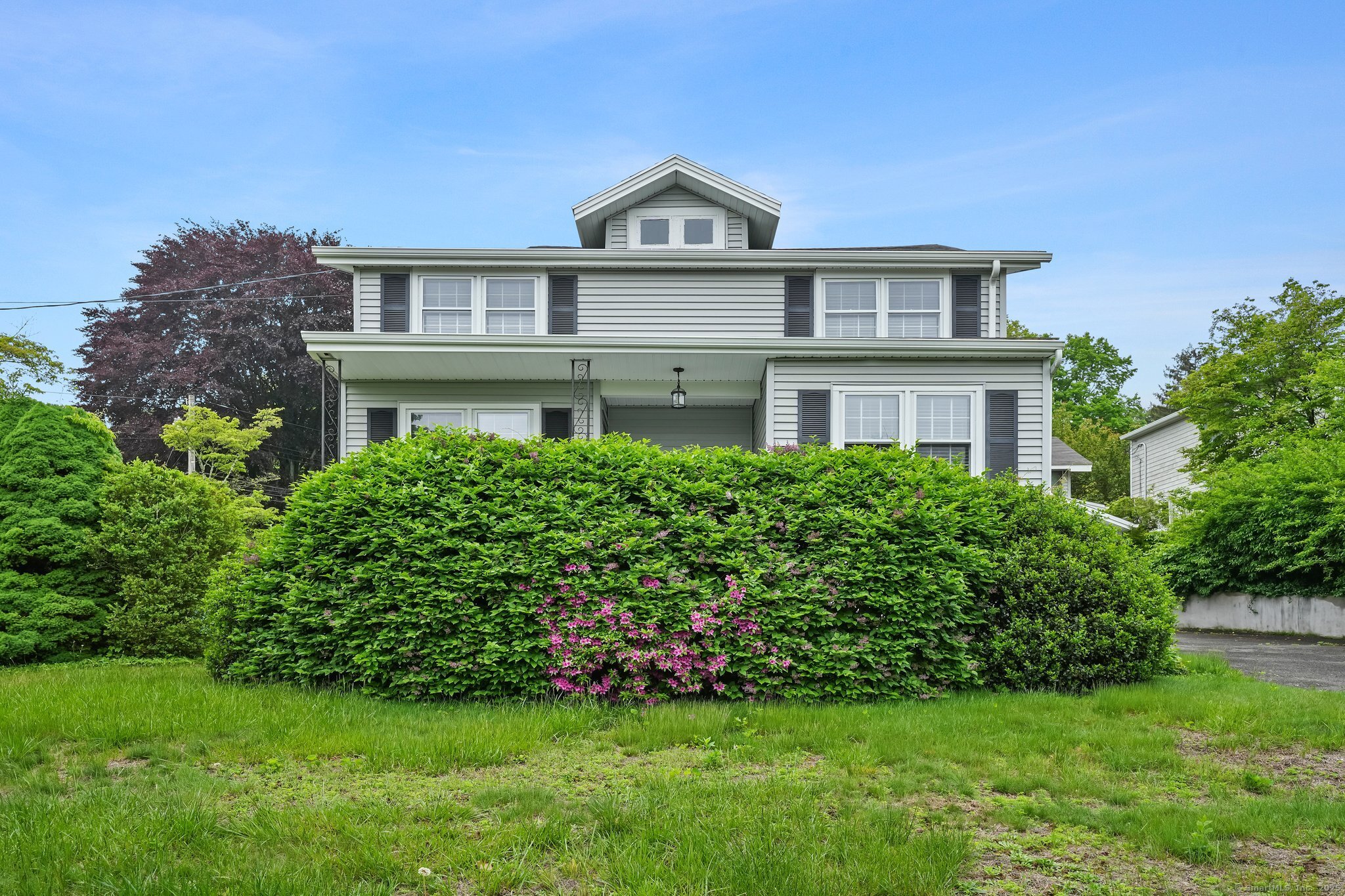 a front view of a house with a garden