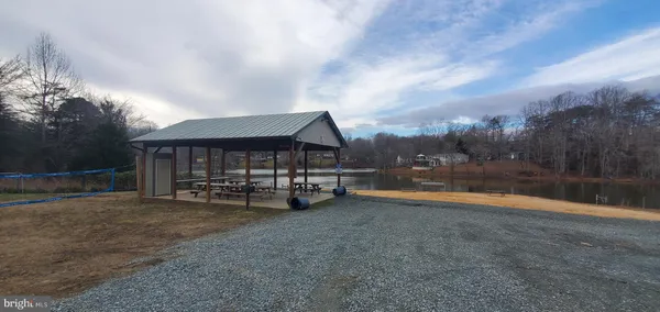a view of a house with swimming pool and sitting area