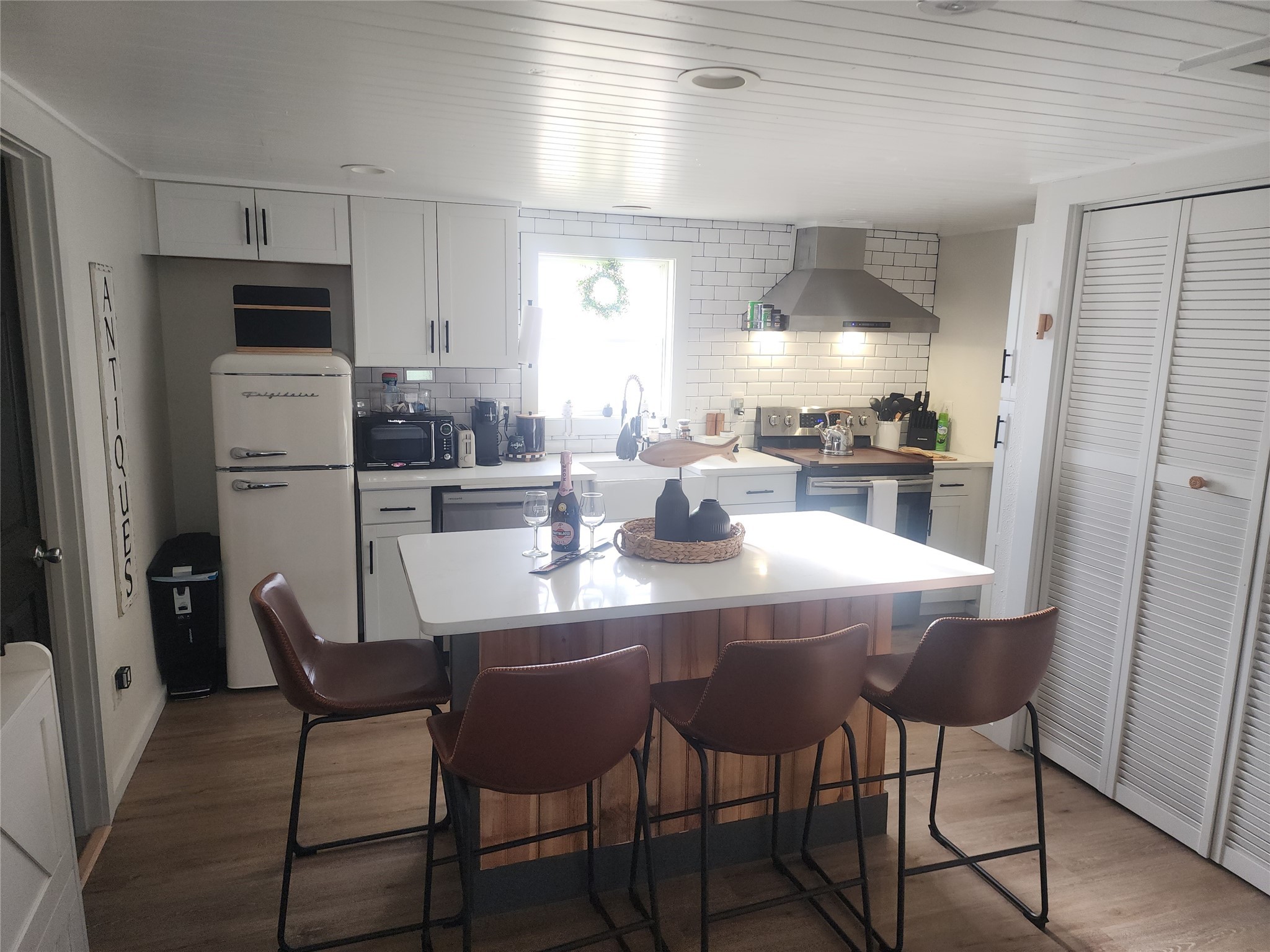 1061 North Sage Road Port Bolivar, TX 77650 - Photo 11 of 21 a kitchen with refrigerator and chairs