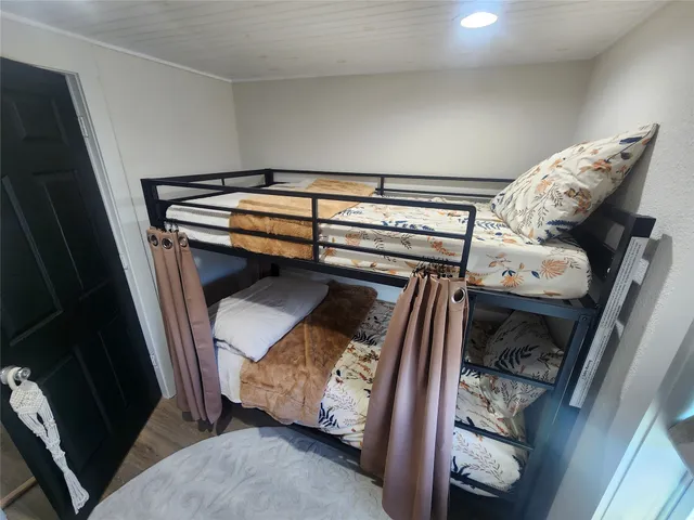 a view of bedroom with furniture and natural light