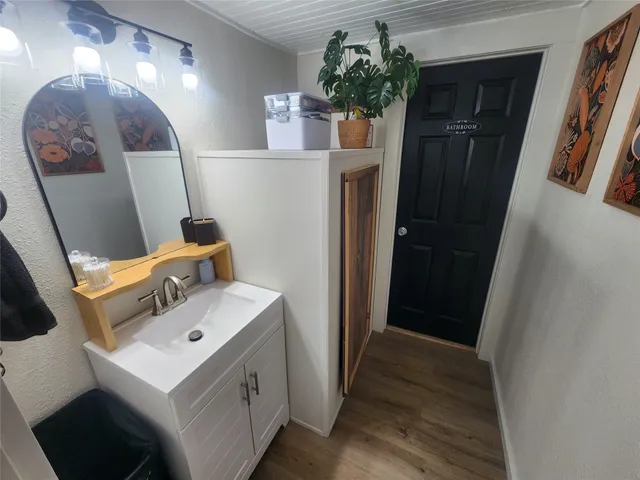 a bathroom with a sink a mirror and vanity