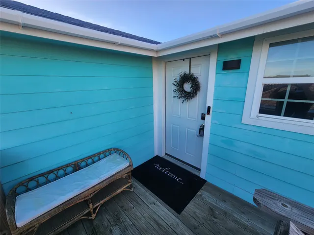 a view of a room with a door and wooden floor