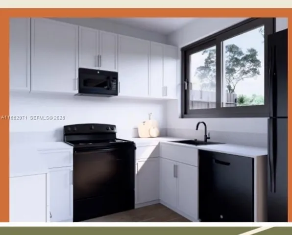 a kitchen with a sink a stove a microwave and cabinets