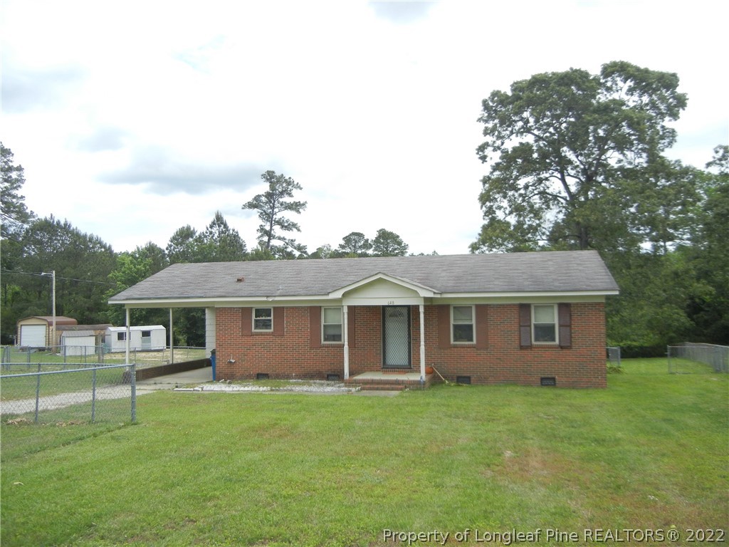 648 Pleasant Loop Fayetteville, NC 28311 - Photo 1 of 20 a view of a yard in front of a house with large trees