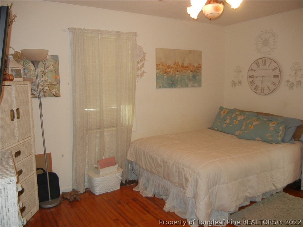 648 Pleasant Loop Fayetteville, NC 28311 - Photo 12 of 20 a bedroom with a bed and a chandelier