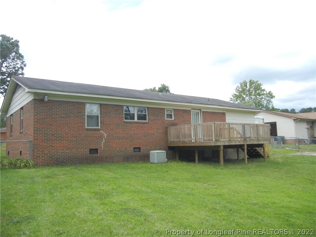 648 Pleasant Loop Fayetteville, NC 28311 - Photo 19 of 20 a backyard of a house with wooden deck and barbeque oven