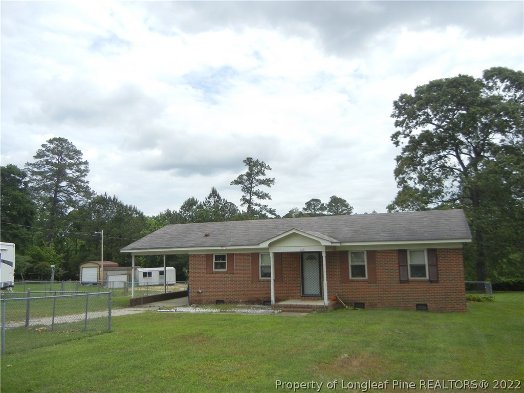 648 Pleasant Loop Fayetteville, NC 28311 - Photo 2 of 20 a front view of a house with a garden