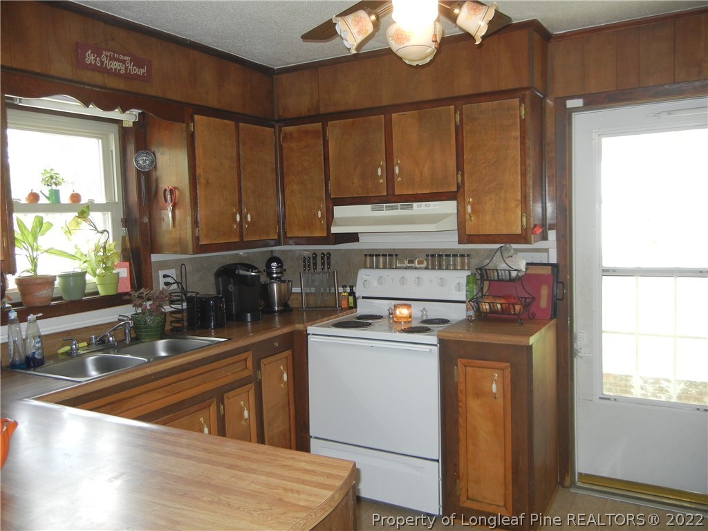 648 Pleasant Loop Fayetteville, NC 28311 - Photo 5 of 20 a kitchen with stainless steel appliances granite countertop a sink a stove and a refrigerator