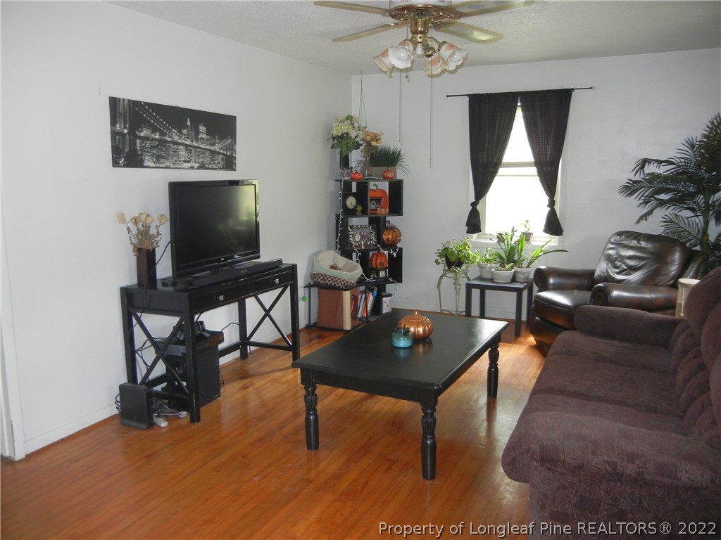 648 Pleasant Loop Fayetteville, NC 28311 - Photo 8 of 20 a living room with furniture and a flat screen tv