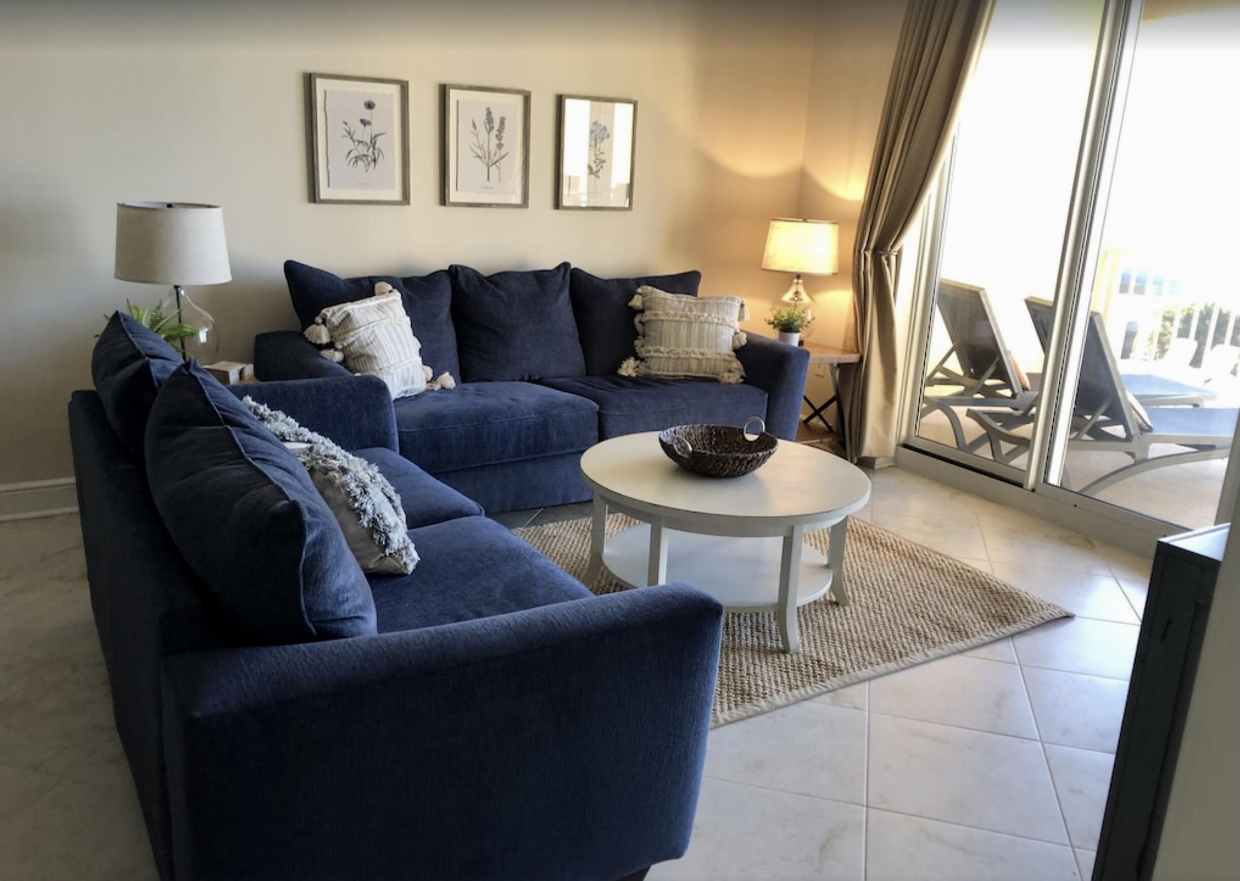 1150 Santa Rosa Boulevard, Unit 211 Fort Walton Beach, FL 32548 - Photo 1 of 7 a living room with furniture and a lamp