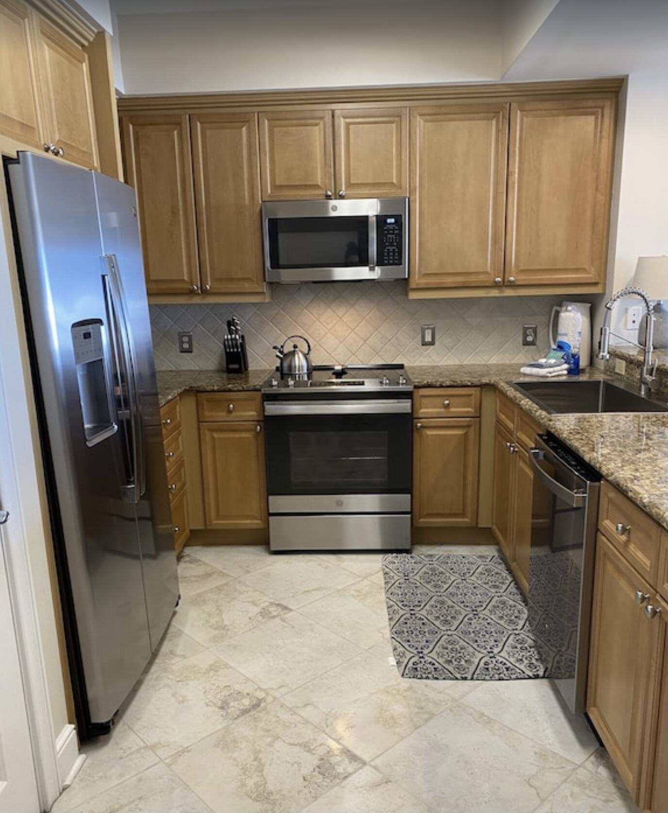 1150 Santa Rosa Boulevard, Unit 211 Fort Walton Beach, FL 32548 - Photo 2 of 7 a kitchen with stainless steel appliances granite countertop a stove a sink dishwasher a refrigerator microwave and cabinets