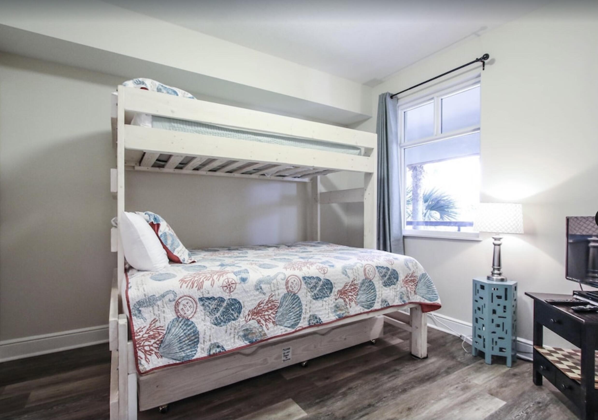 1150 Santa Rosa Boulevard, Unit 211 Fort Walton Beach, FL 32548 - Photo 6 of 7 a bedroom with a bed and wooden floor