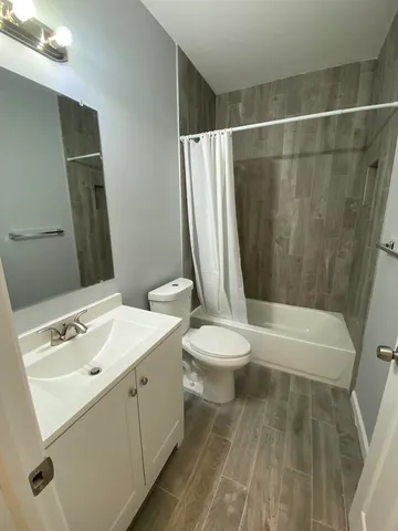 a bathroom with a sink a toilet and a bathtub