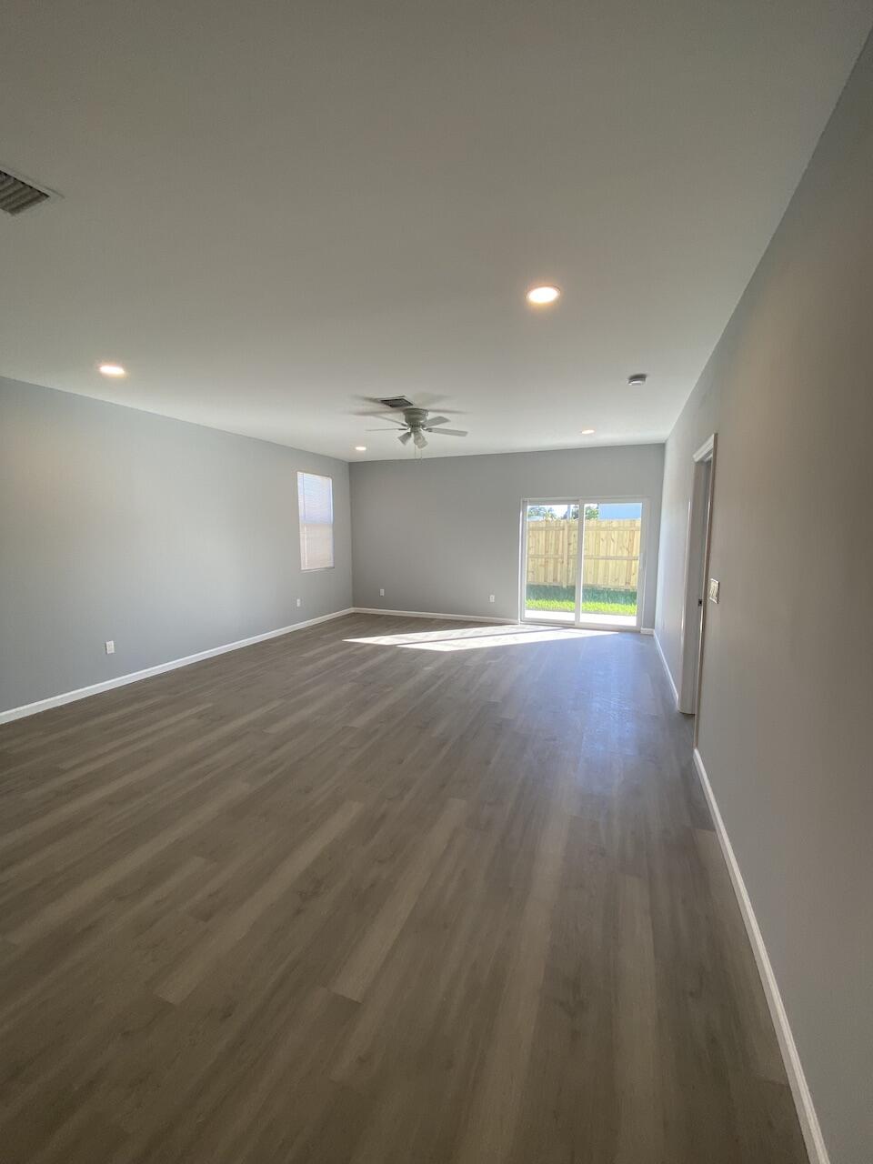 514 Northwest 11th Avenue Boynton Beach, FL 33435 - Photo 5 of 18 an empty room with wooden floor and windows