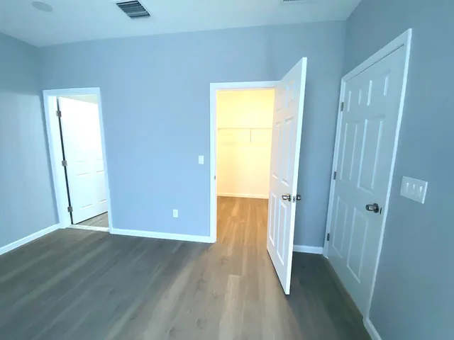 a view of a room with wooden floor and a window