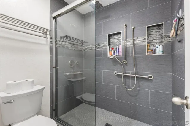a bathroom with a toilet sink and shower