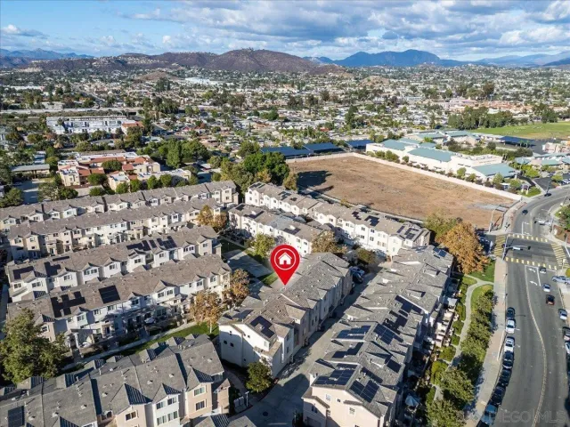 an aerial view of residential houses with outdoor space