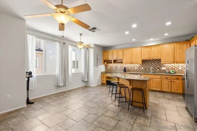 a large kitchen with a table and chairs