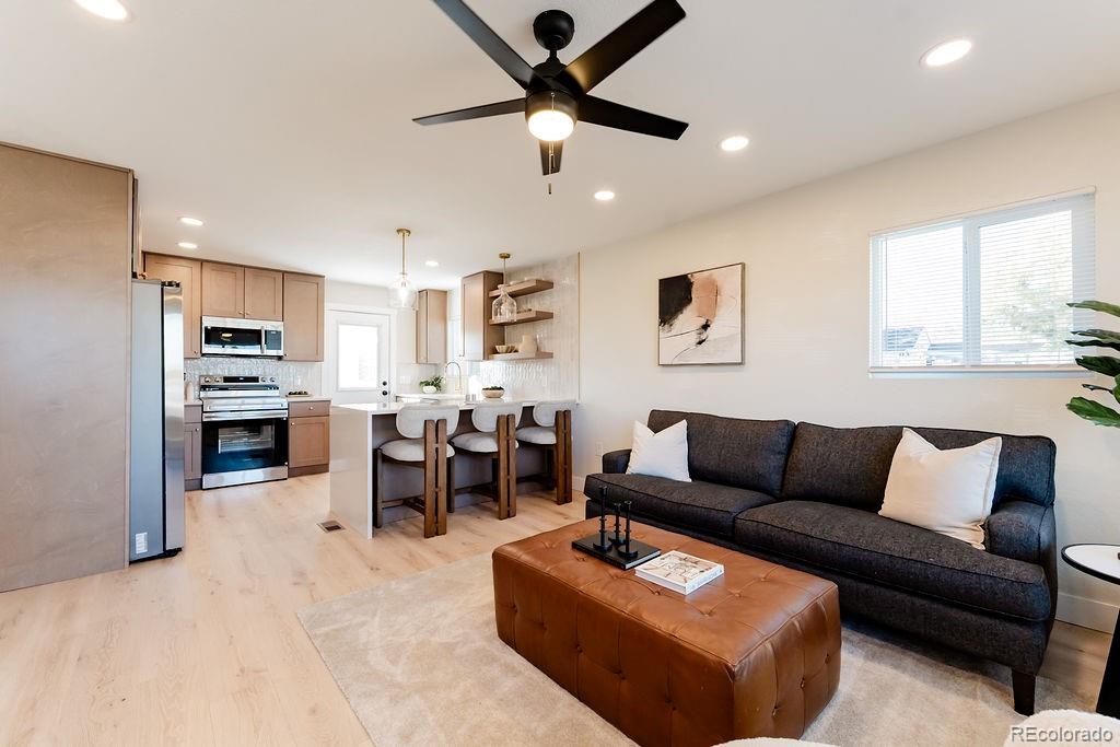 1105 South Raleigh Street Denver, CO 80219 - Photo 13 of 23 a living room with furniture kitchen view and a window