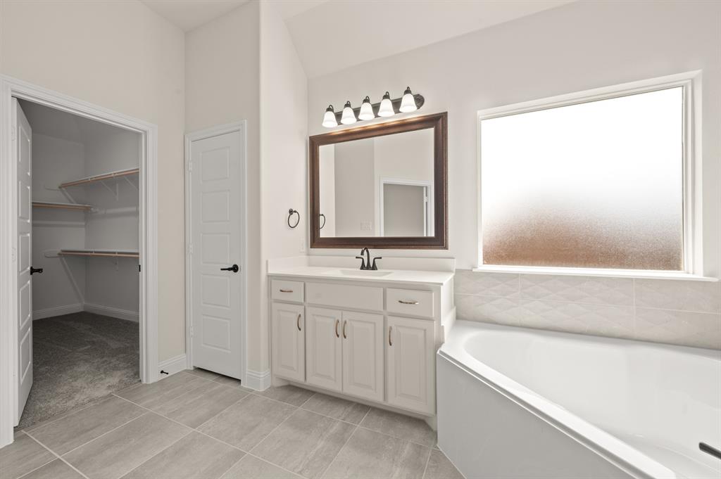 104 Calf Lane Midlothian, TX 76065 - Photo 11 of 29 a bathroom with a tub sink and mirror