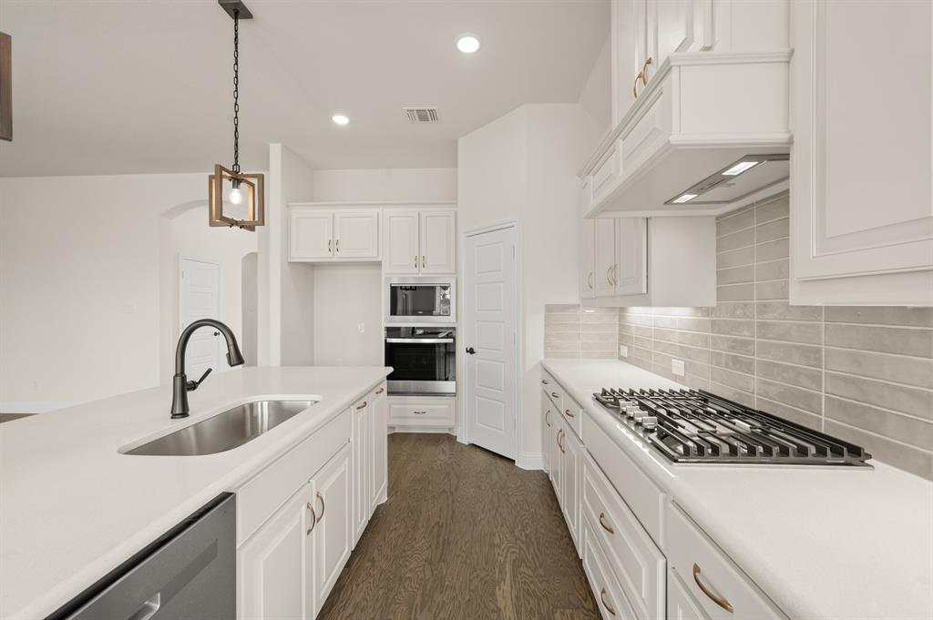 104 Calf Lane Midlothian, TX 76065 - Photo 2 of 29 a kitchen with kitchen island a sink appliances and cabinets