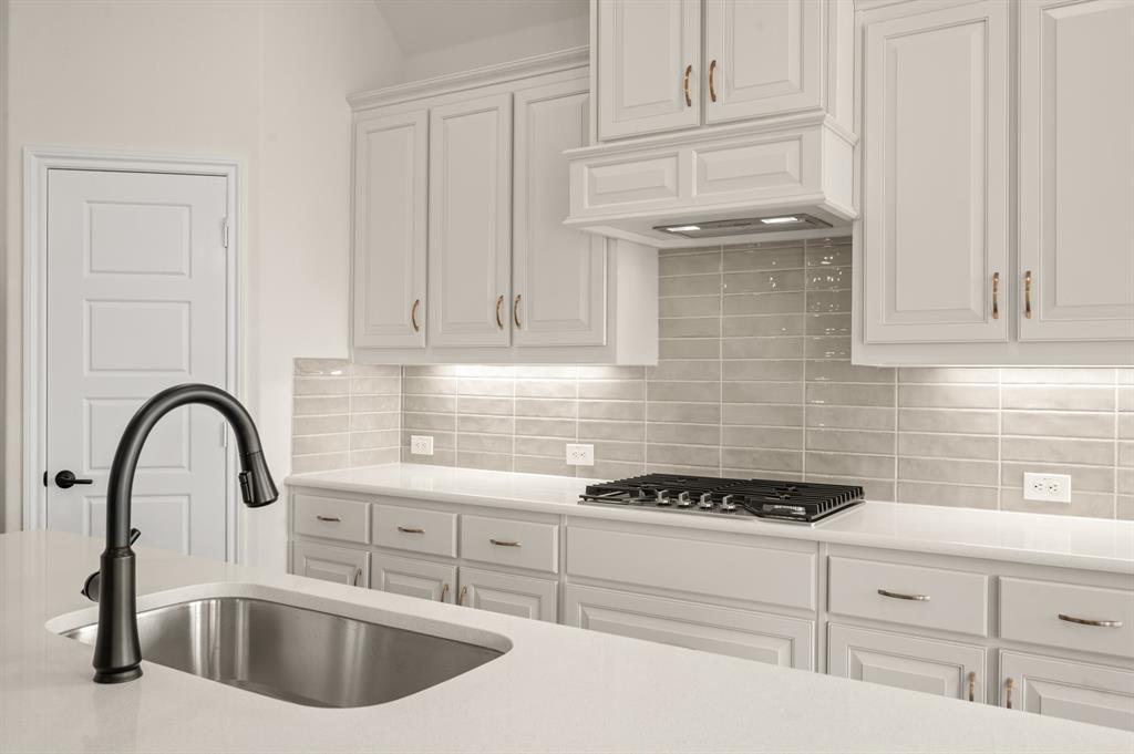 104 Calf Lane Midlothian, TX 76065 - Photo 3 of 29 a kitchen with stainless steel appliances kitchen island a sink a stove and cabinets