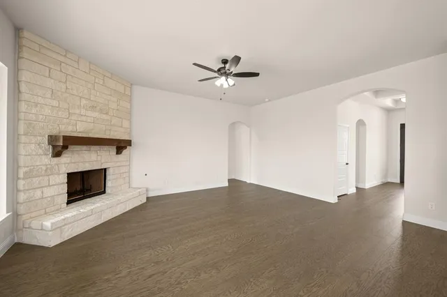 a view of an empty room with a fireplace
