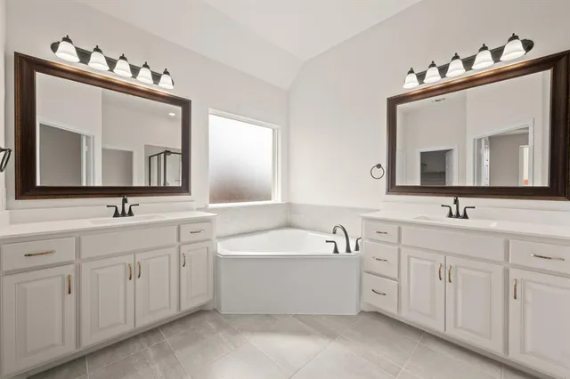 a bathroom with a double vanity sink and mirror