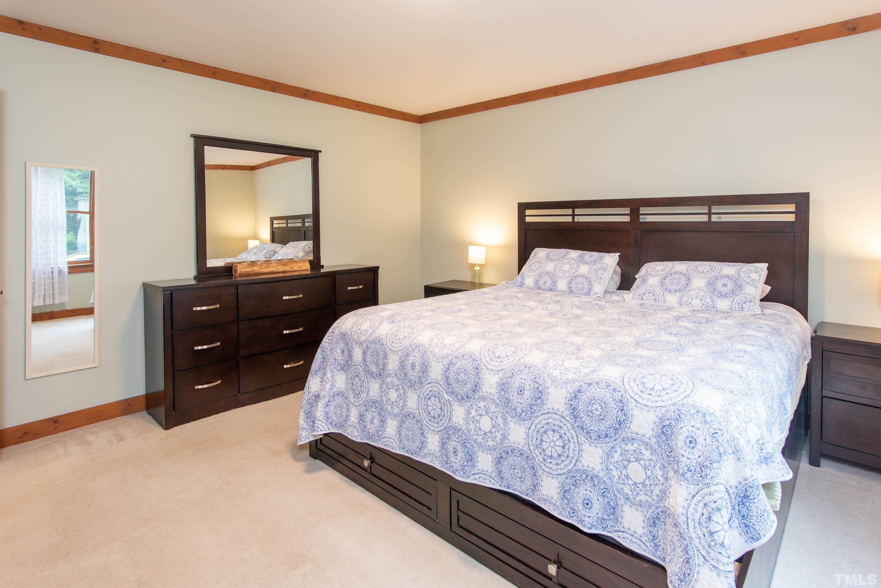 4225 Tolchester Place Raleigh, NC 27613 - Photo 16 of 35 a bedroom with a bed and a dresser
