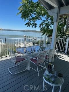 a view of a patio with couches chairs potted plants and wooden floor