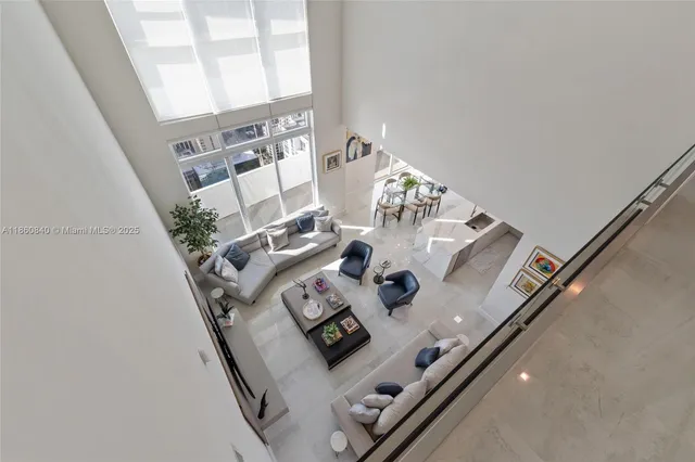 a view of living room with furniture and floor to ceiling window