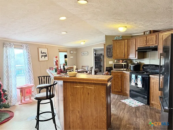 a kitchen with counter top space cabinets and appliances