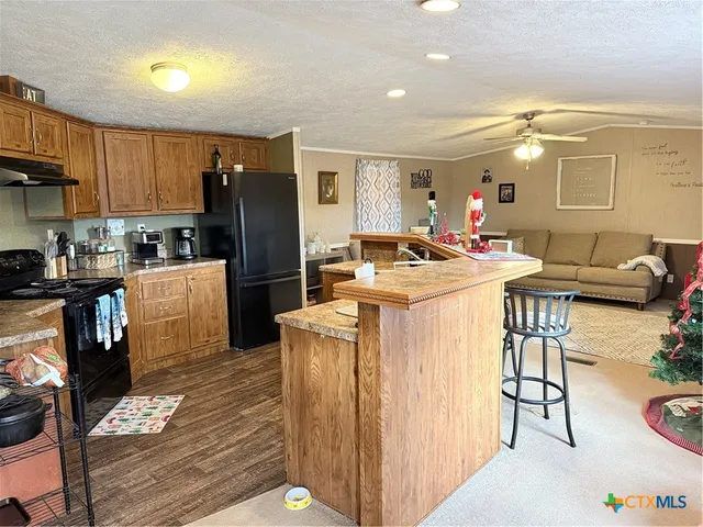 a kitchen with sink refrigerator and cabinets