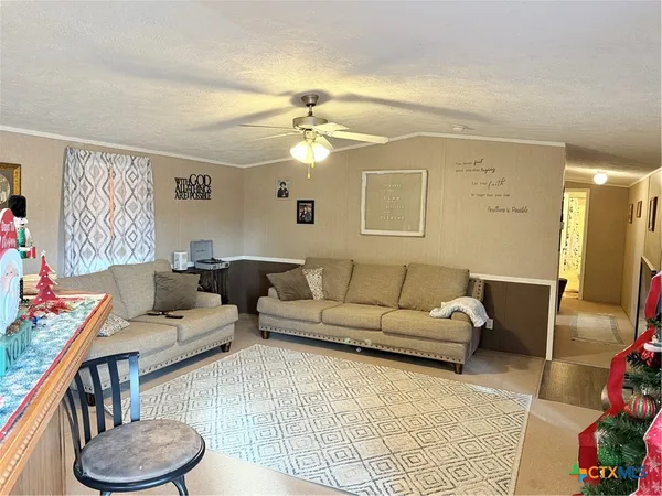 a living room with furniture and a chandelier