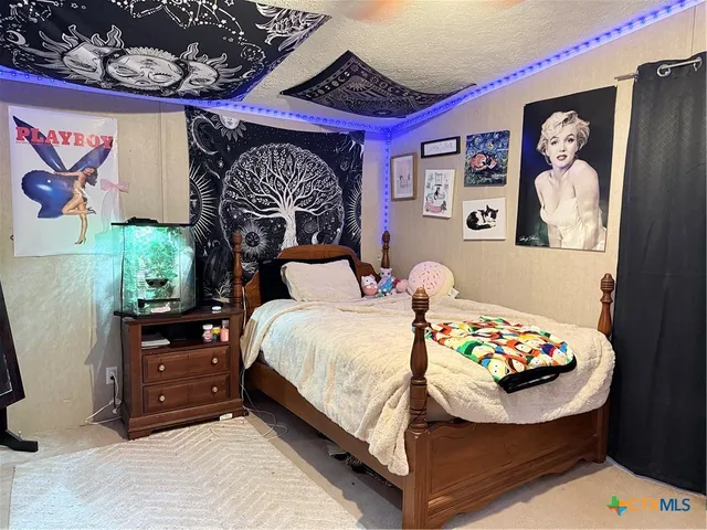 a bedroom with bed and a window