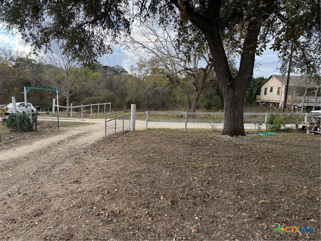 107 Dallas Street Goliad, TX 77963 - Photo 25 of 28 a view of outdoor space with deck and trees